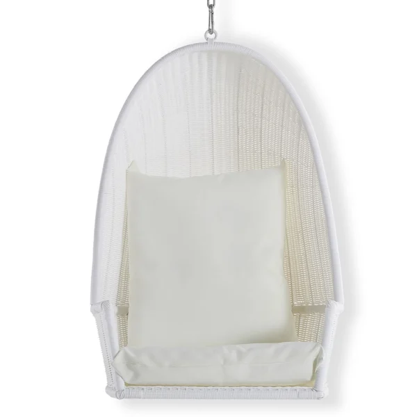 A white hanging chair with pillow on top of it.