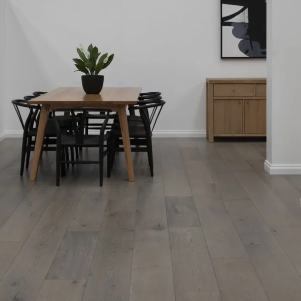 A dining room table and chairs in front of a wall.