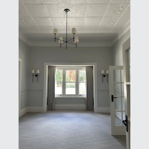 A room with a window and chandelier in it