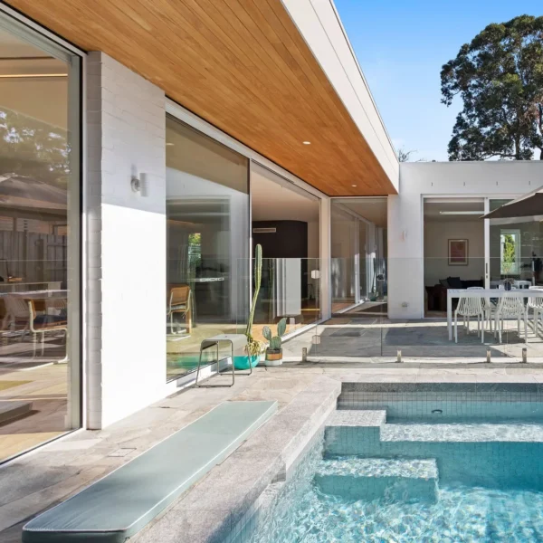 A pool with a large glass sliding door.