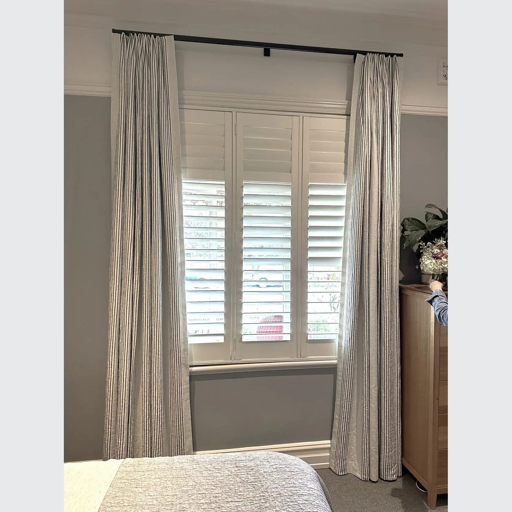 A bedroom with curtains and blinds in it