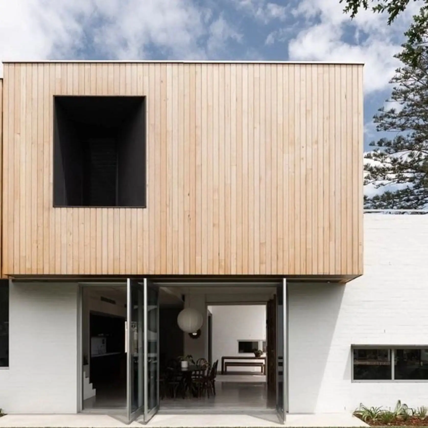 A large white building with wood siding on the front.