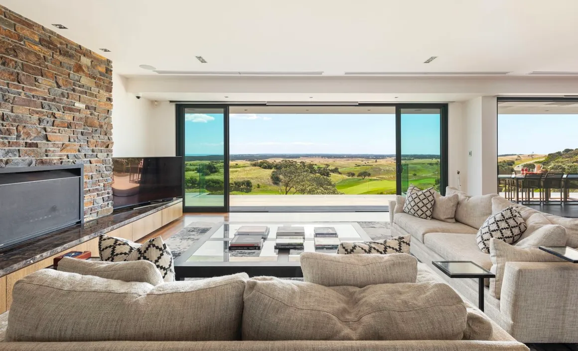 A living room with couches and a television.