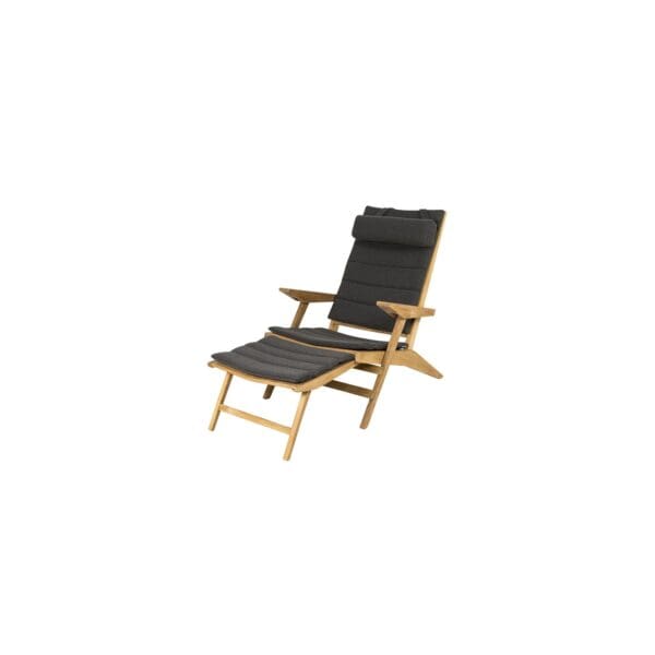 A wooden chair with black seat cushion and foot rest.