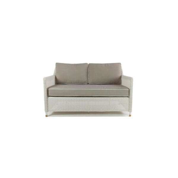 A white couch with grey cushions on top of it.