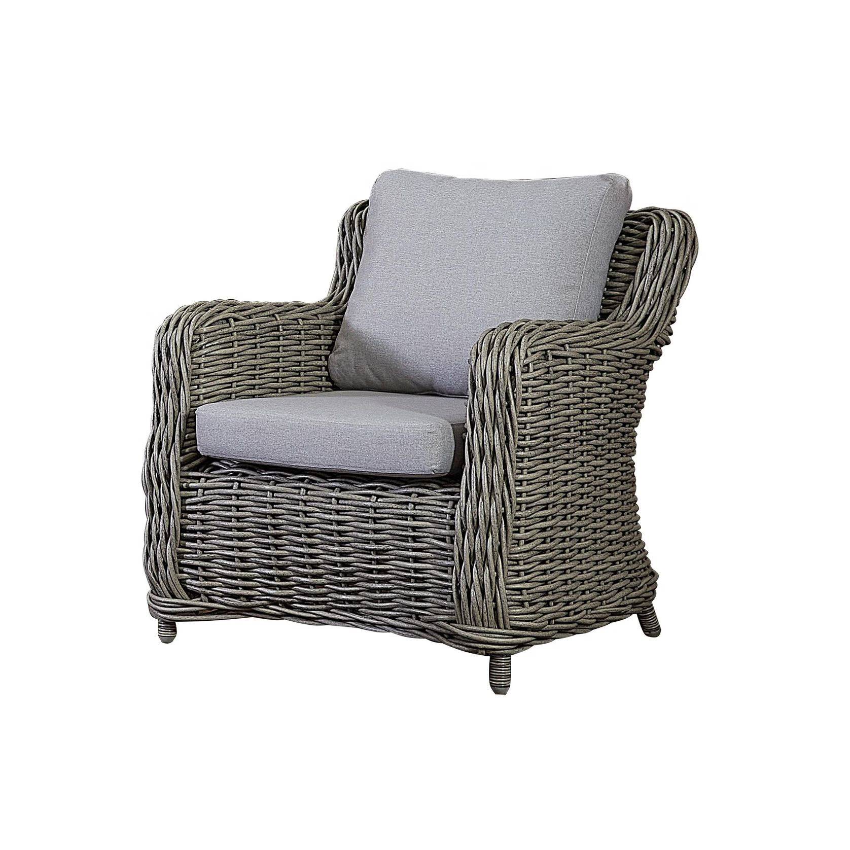 A wicker chair with grey cushions on top of it.