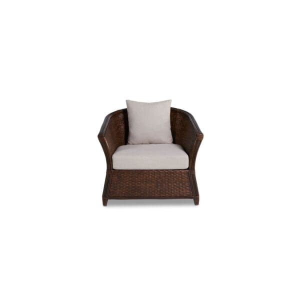 A brown chair with white cushions on top of it.