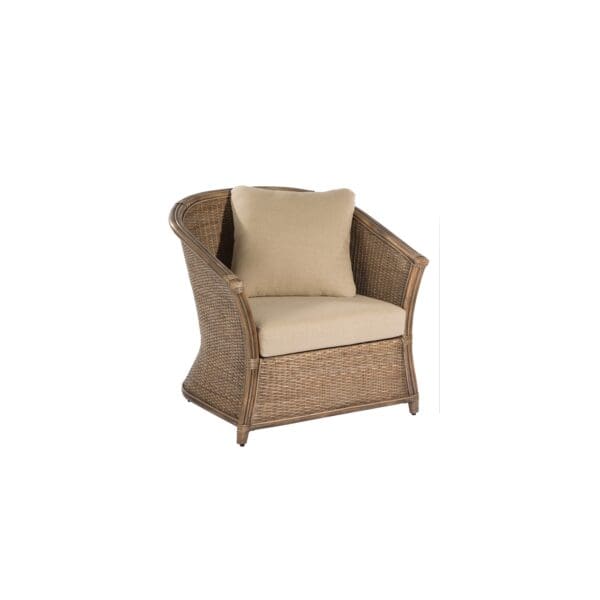 A wicker chair with beige cushions on top of it.