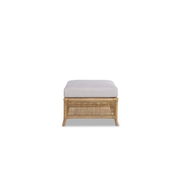 A white ottoman with a wooden frame and cushion.