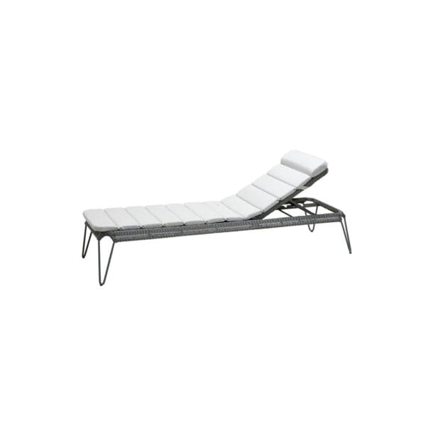 A white lounge chair with a metal frame.