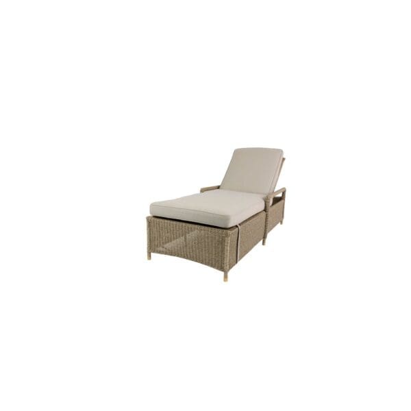 A white and brown lounge chair with a pillow.