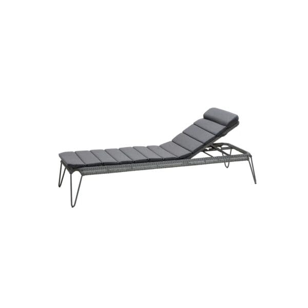 A black lounge chair with metal legs.