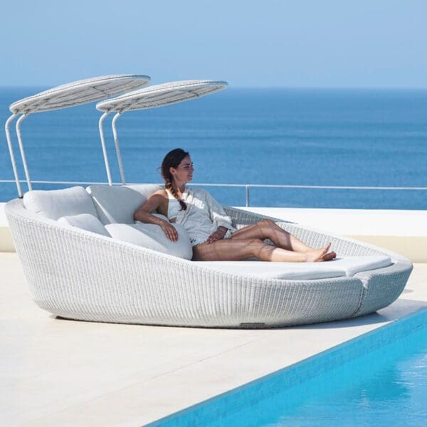 A woman sitting on top of a white boat.