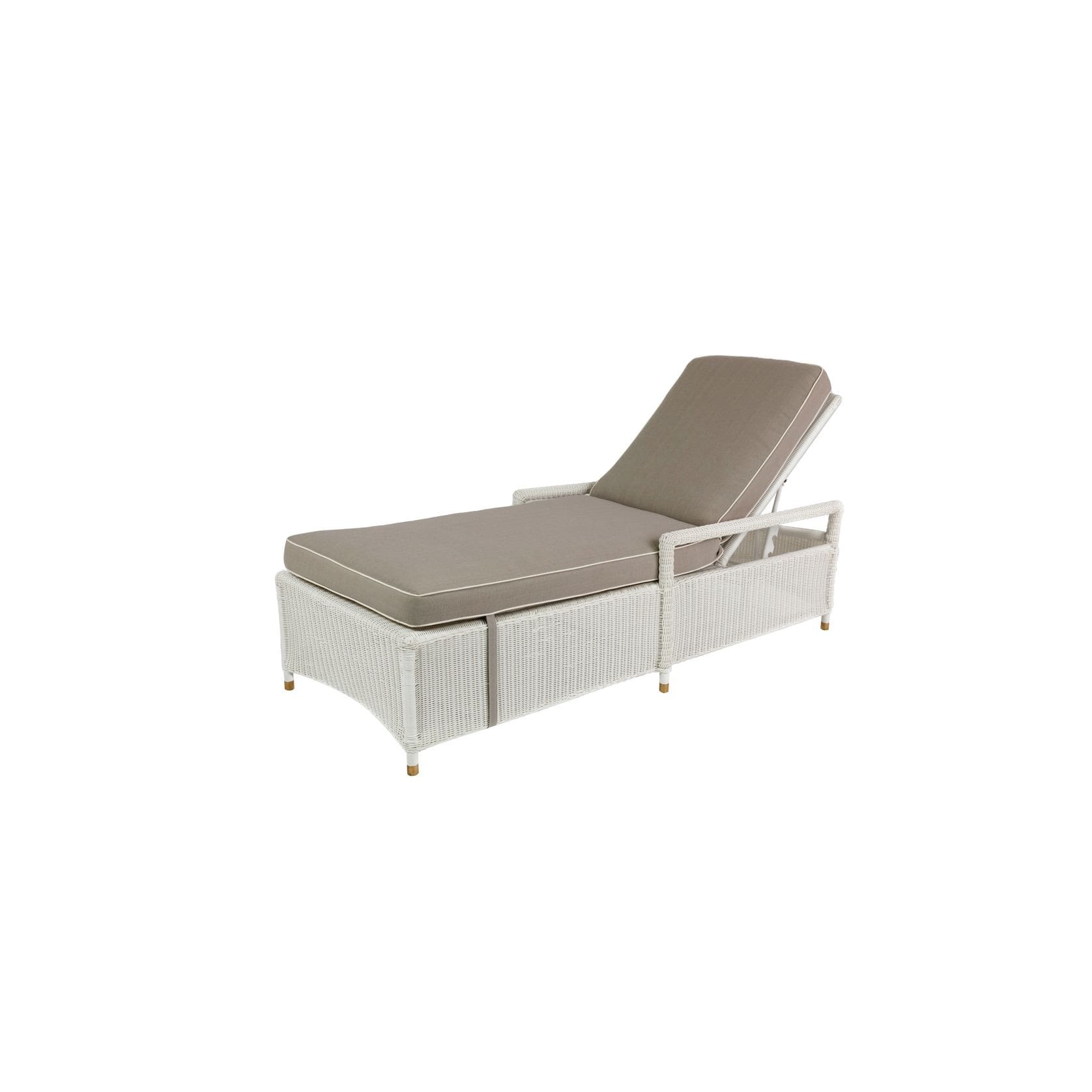 A white lounge chair with brown cushion on top of it.