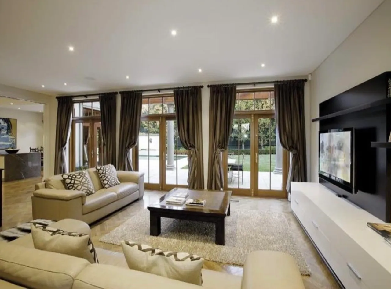 A living room with couches and a television.