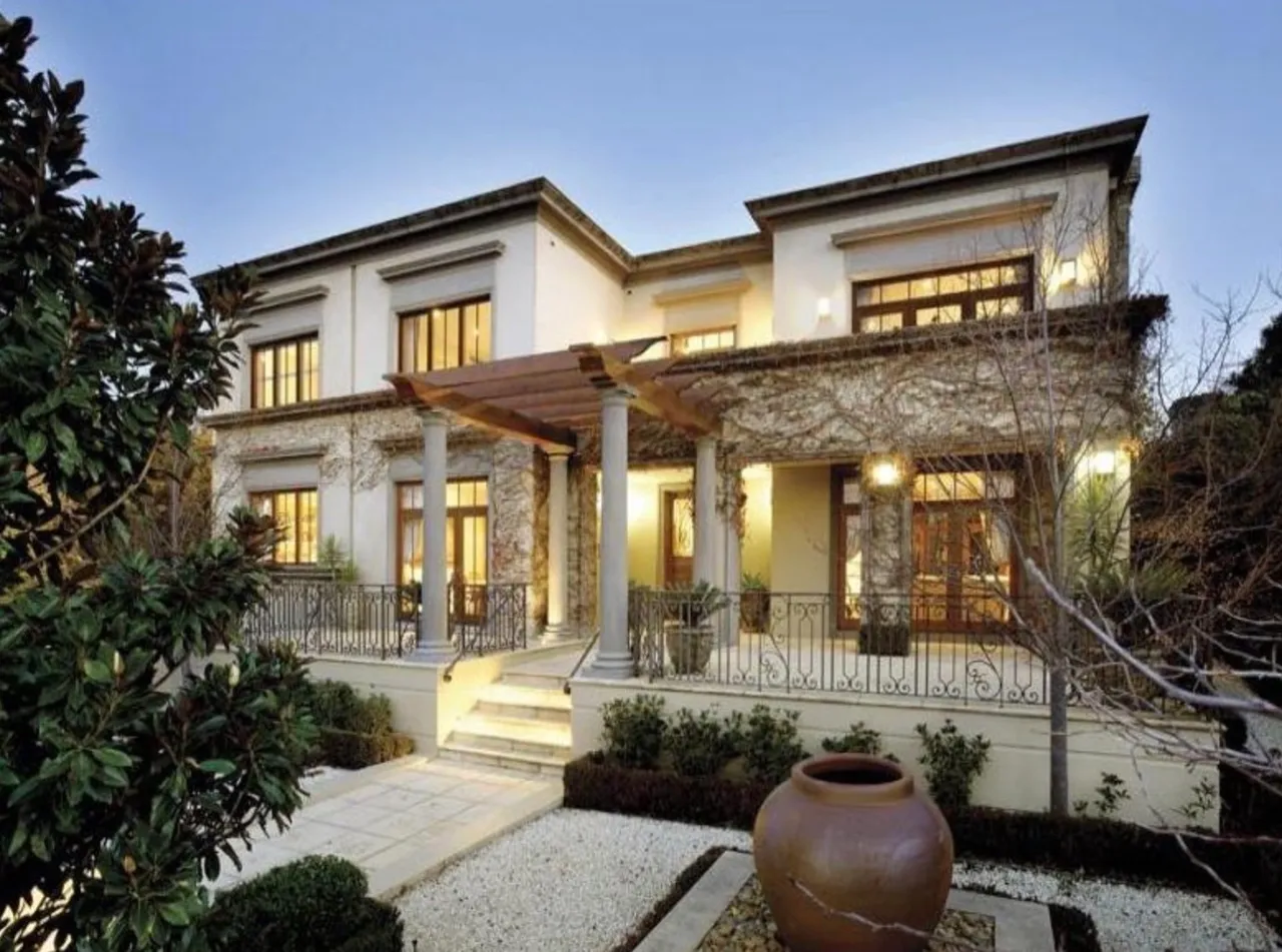 A large white house with a porch and patio.